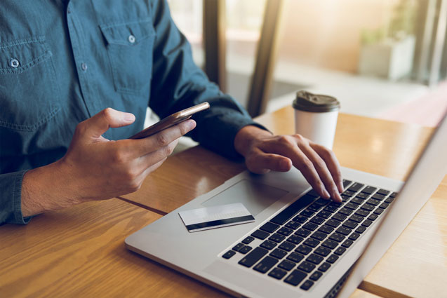 Man using CLX E-commerce on laptop and smartphone